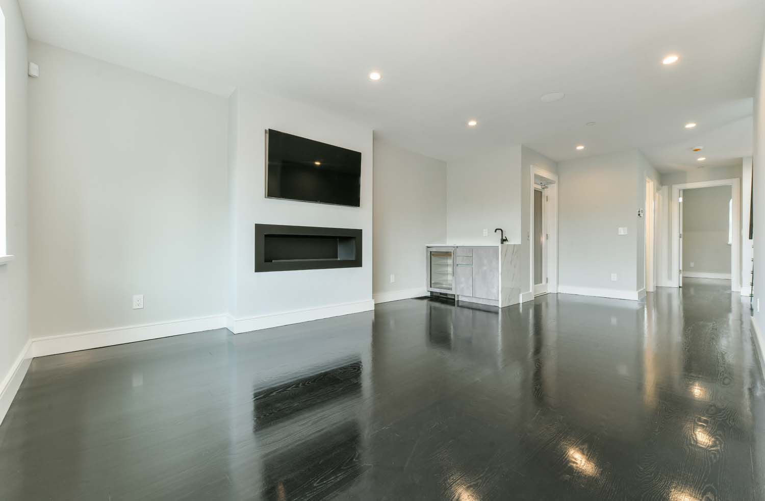empty living room with tv and fireplace