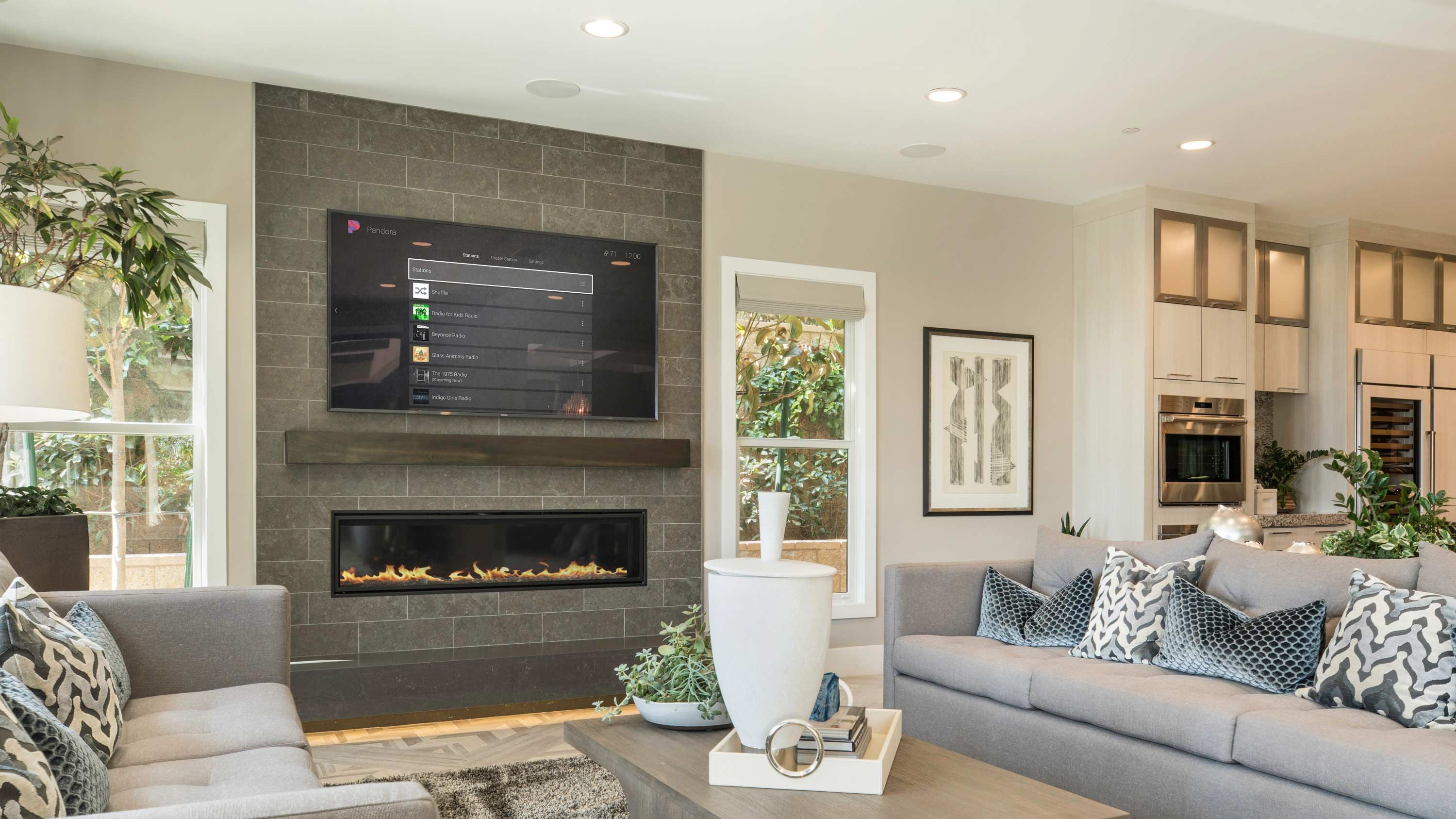 control4 interface on tv on brick wall in living room