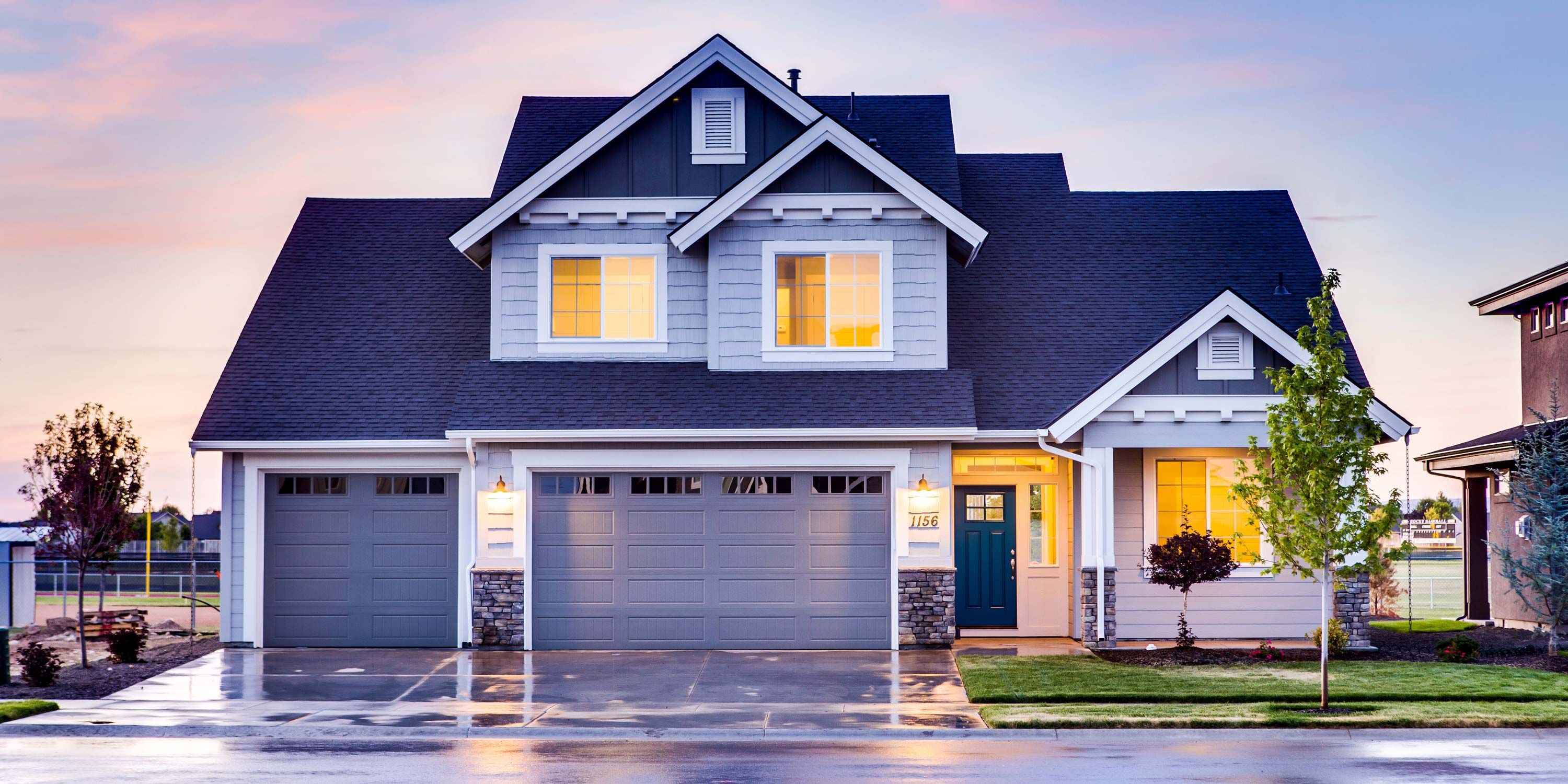 Blue Home with blue garage, sunset, two garages