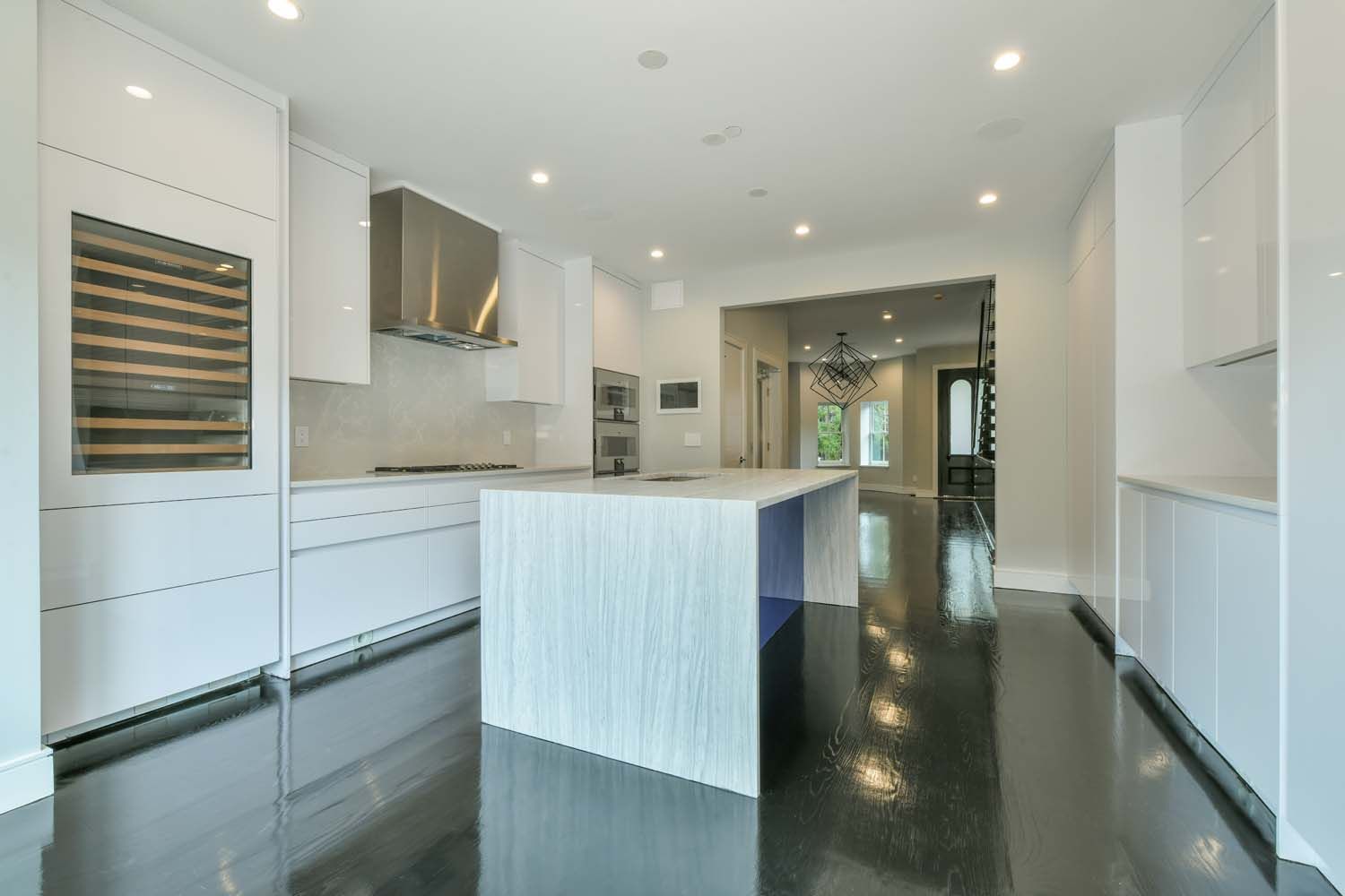 white kitchen with dark floors